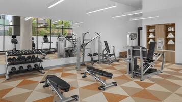 Un gimnasio con diferentes equipos de ejercicio, un espejo grande y un suelo estampado.