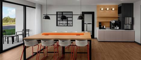 A modern kitchen with a wooden countertop, a built-in oven, and a coffee machine.