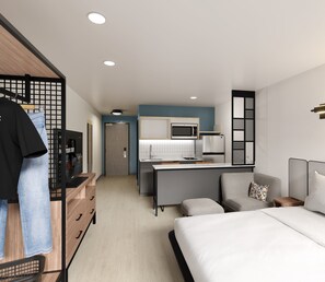 A modern hotel room with a kitchenette, a bed, a seating area, and a wardrobe. - StudioRes by Marriott Fort Myers Airport (Fort Myers)