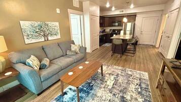 A modern living room with a sofa, coffee table, and rug.