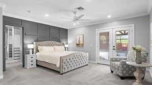 A bedroom with a large bed, a bedside table, a chair, and a small table with a vase. - Family Paradise-Kid and Pet Friendly Home by Encanto Golf Course-Downtown  Phx. (Phoenix)