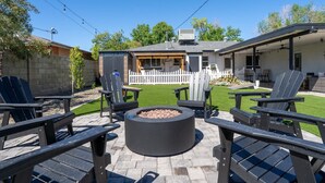 A backyard with a fire pit, outdoor seating, and a covered patio area. - Family Paradise-Kid and Pet Friendly Home by Encanto Golf Course-Downtown  Phx. (Phoenix)