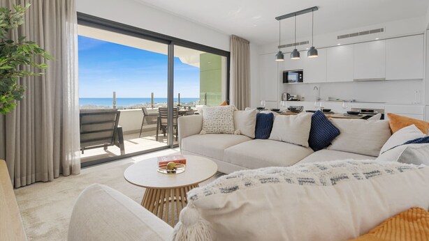 A modern living room with a large sofa, a round coffee table, and a view of the ocean. - Mariposa | Sea view - pool - terrace - spa (La Cala de Mijas)