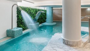 An indoor pool with a water feature, surrounded by tiled walls and a column. - Mariposa | Sea view - pool - terrace - spa (La Cala de Mijas)