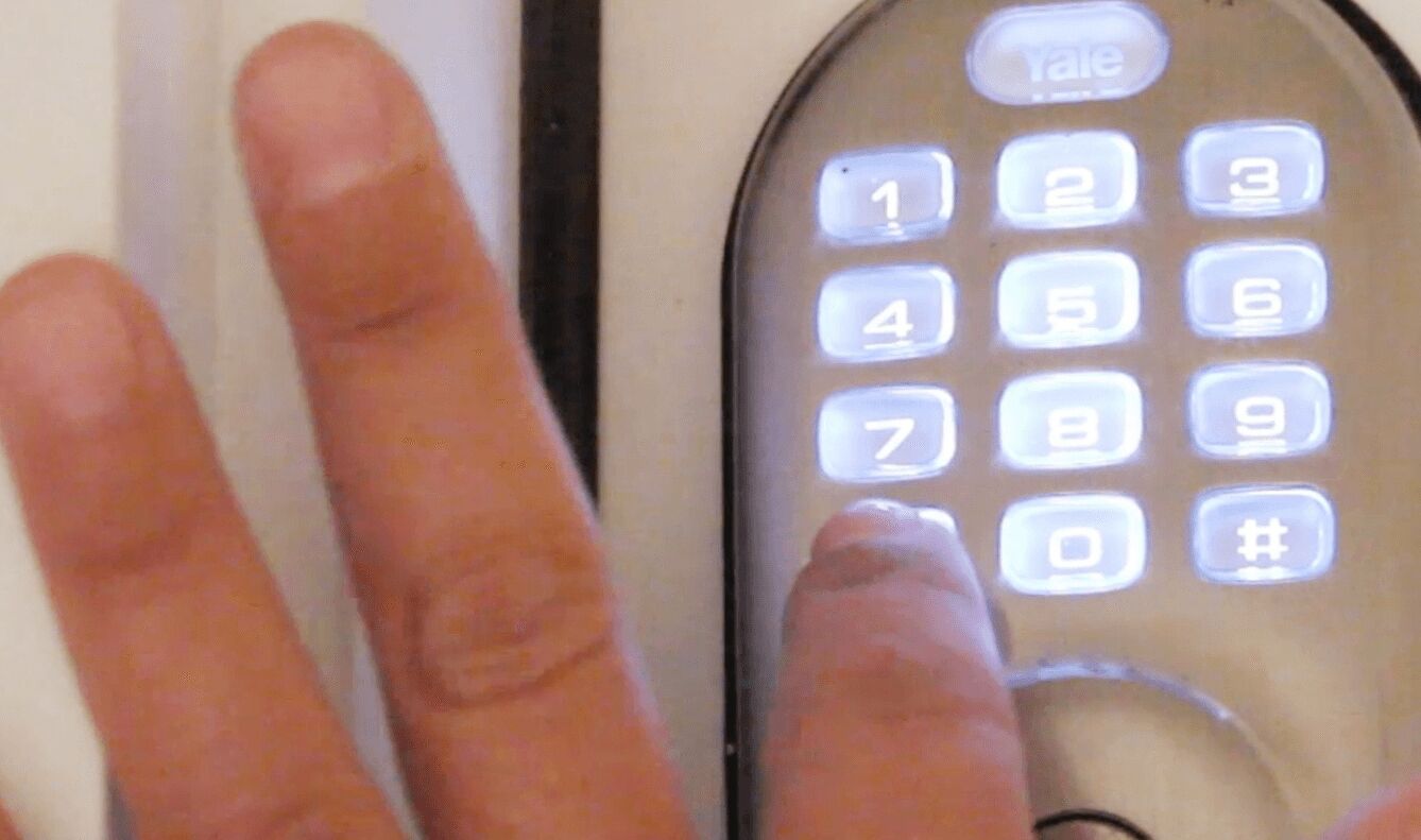 A close-up of a keypad with illuminated numbers and symbols, including a call button and a '#' key.