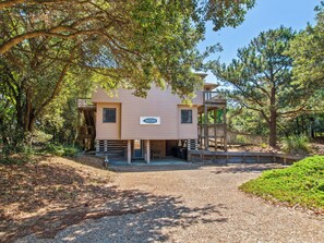 A two-story beach house with a deck and a sign that reads "The Beach House". - The Beach House: Pool, Walk to Beach, Quiet OBX (Southern Shores)