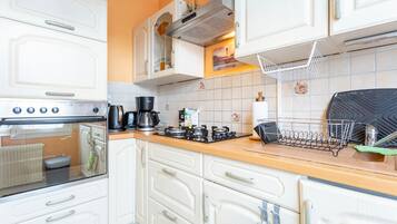 Fridge, microwave, coffee/tea maker, cookware/dishes/utensils