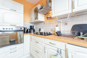 Fridge, microwave, coffee/tea maker, cookware/dishes/utensils