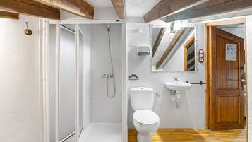 A bathroom with a shower, toilet, and sink.