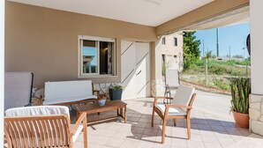 A covered patio with wooden furniture, a window, and a view of the landscape. - Apartment 'Elena' with Mountain View, Wi-Fi and Air Conditioning (Alcamo)