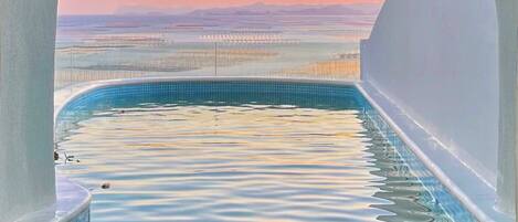 Seasonal outdoor pool, open 6:00 AM to 9:00 PM, pool umbrellas