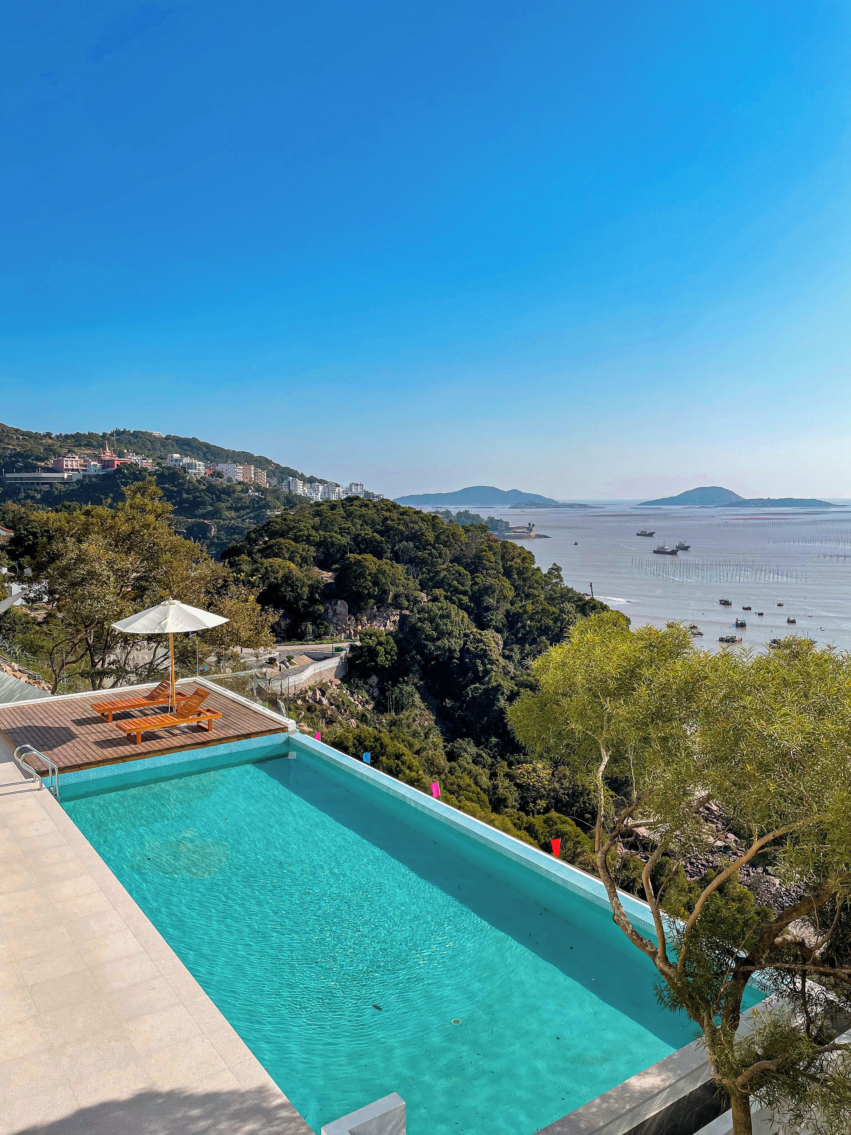 Seasonal outdoor pool, open 6:00 AM to 9:00 PM, pool umbrellas