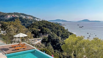 Seasonal outdoor pool, open 6:00 AM to 9:00 PM, pool umbrellas