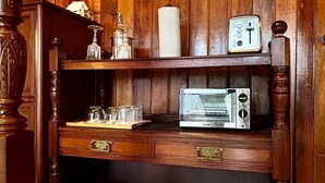 A wooden cabinet with a microwave, a glass jar, and a coffee mug. - Quiet & Cozy Room in a SPA Environment (Nanoose Bay)