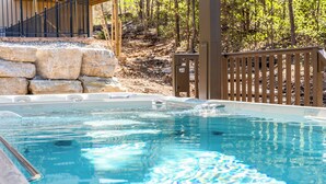 A swimming pool with a wooden deck and stone steps leading to a hot tub area. - HUGE Private Heated Swim Spa • Game Room • 7BR/7BA • Entire home • Work Space (Hollister)