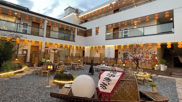 A courtyard with outdoor seating, lanterns, and a traditional boat. - Lin an Hot Spring Story Family Homestay (Hangzhou)