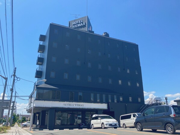 A multi-story hotel building with a sign reading "HOTEL L'VEMAX". - HOTEL LiVEMAX Tendo (Tendo)