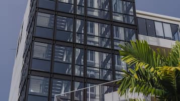 A modern building with a glass facade and a metal framework.