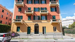 A multi-story building with balconies, a central entrance, and a no parking sign. - Apartment Vernazzola In Genova, Genova, Italy (Genova)