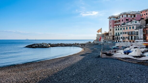 A coastal area with a pebbly beach, boats, and colorful buildings. - Apartment Vernazzola In Genova, Genova, Italy (Genova)