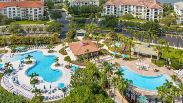 Relax by the resort's large, winding pool surrounded by lounge areas and lush greenery.
