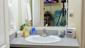 A bathroom with a white sink, a mirror, and a camera on a tripod in the background. - Quiet Yet Close To Restaurants, Downtown, Coronado (San Diego)