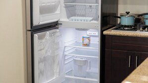 An open refrigerator with shelves and a freezer compartment. - Quiet Yet Close To Restaurants, Downtown, Coronado (San Diego)