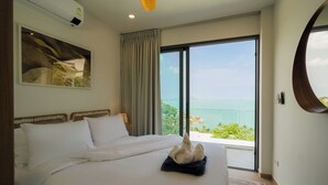 A hotel room with a large bed, a view of the sea, and a painting on the wall. - Staylar Seaview Pool Villa - Coral Cove, Koh Samui CC2 (Koh Samui, Coral Cove)