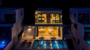 A modern two-story house with a swimming pool, a dining area, and a living room with a sofa and a coffee table. - Staylar Seaview Pool Villa - Coral Cove, Koh Samui CC2 (Koh Samui, Coral Cove)