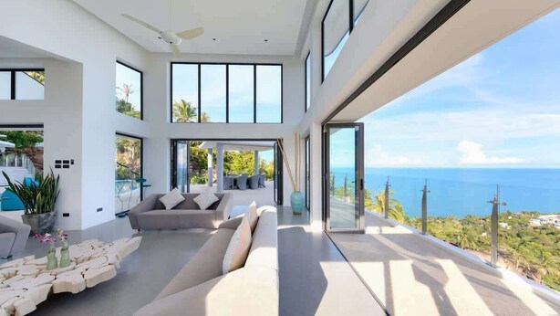A modern living room with a large sofa, a coffee table, and a view of the ocean. - Staylar Luxury Seaview Pool Villa Maeva, Koh Samui (Koh Samui, Chaweng Noi)