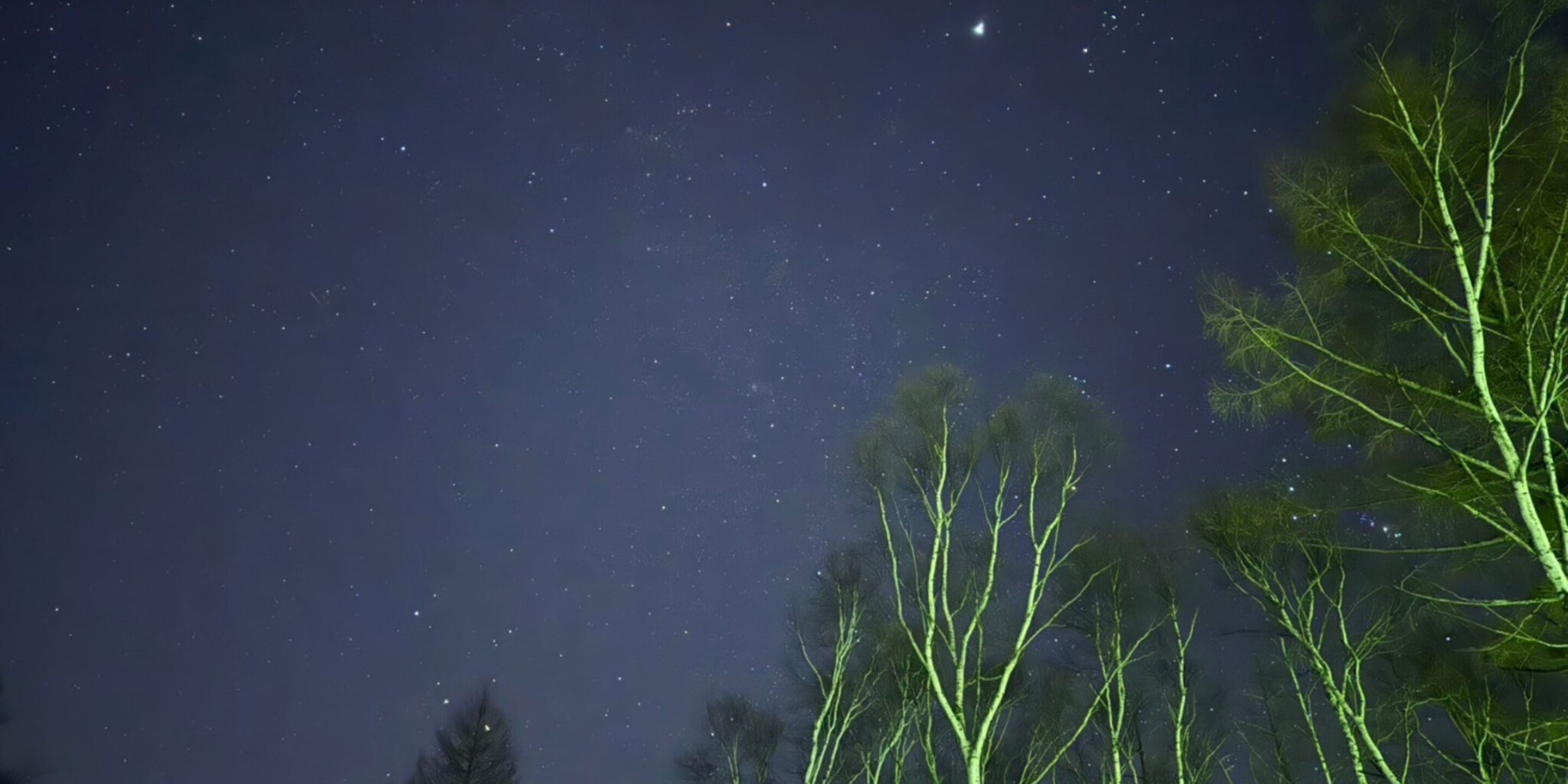 A night sky with stars and a visible moon.