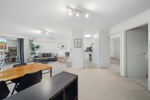 A modern interior with a dining area, kitchen, and living space.