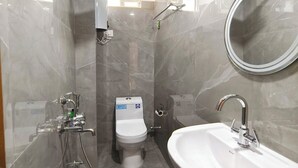 A modern bathroom with a toilet, sink, and shower. - Aurora The Mall Darjeeling (Darjeeling)