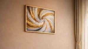 A room with two armchairs, a round wooden table, a fluffy rug, and a wall-mounted abstract painting. - Noaz Hotel  (Kampala)