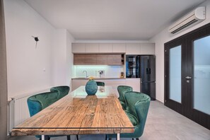 Enjoy meals in the kitchen with oven and refrigerator, and dine at the wooden table with comfortable seating.