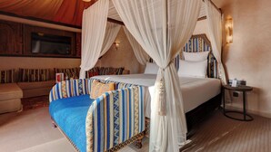 A room with a bed, a sofa, and a small table. - Palmeraie Oasis Camp - A Member Of Barcelo Hotel Group (Marrakech)