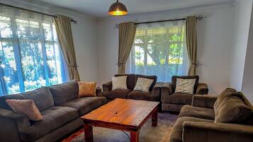 Comfort Villa | Living area | 55-inch Smart TV with cable channels