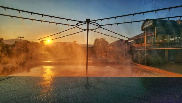 A water feature with a central structure and a building labeled "MAP RESORT" in the background. - Map Resort (Alibag)