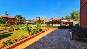 A resort with multiple buildings, a pool area, and well-maintained gardens. - Map Resort (Alibag)