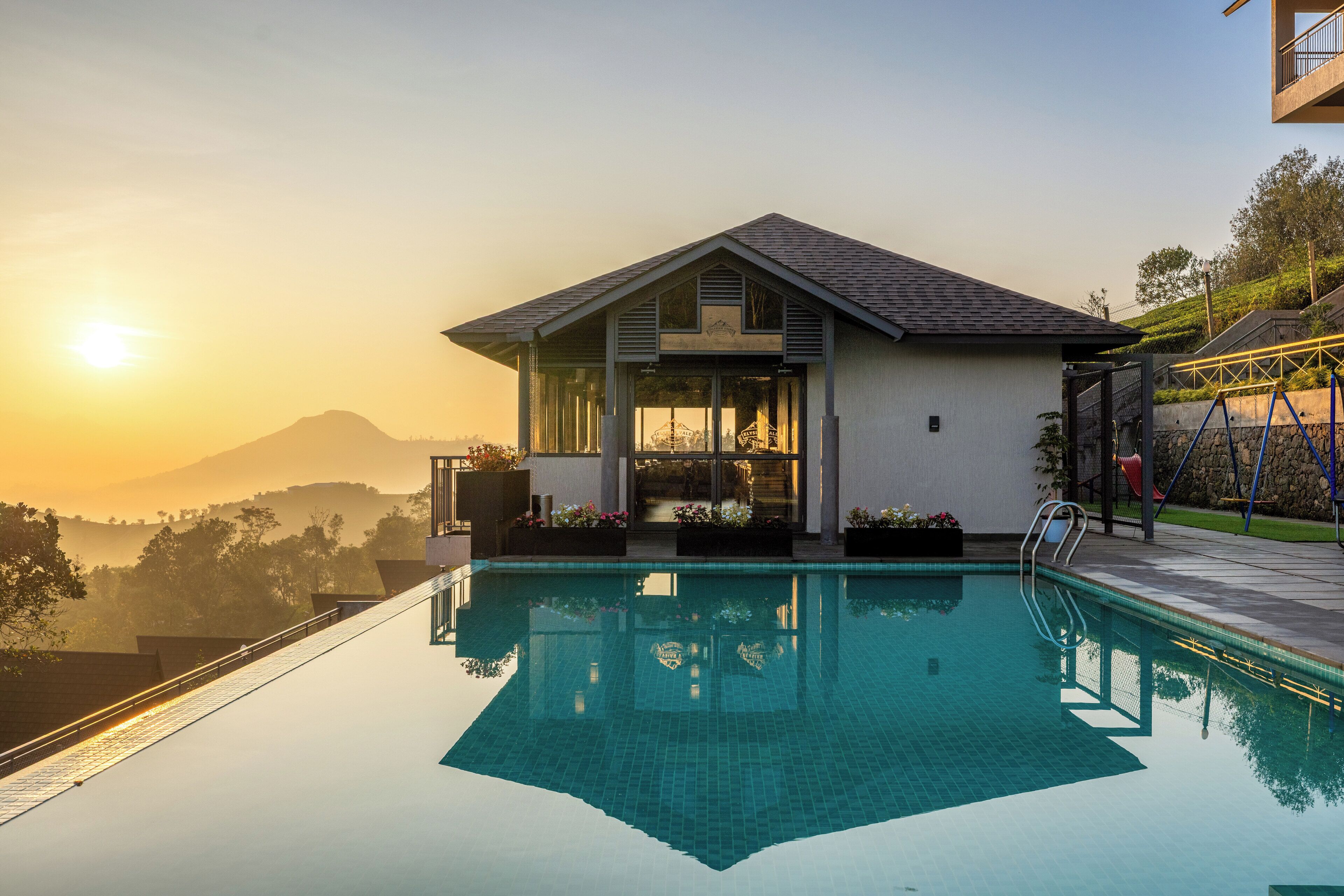 Una piscina al aire libre, sombrillas, sillones reclinables de piscina