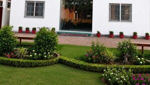A white building with a sign reading 'RAMALYAM' and multiple windows. - Ramalayam (Faizabad)