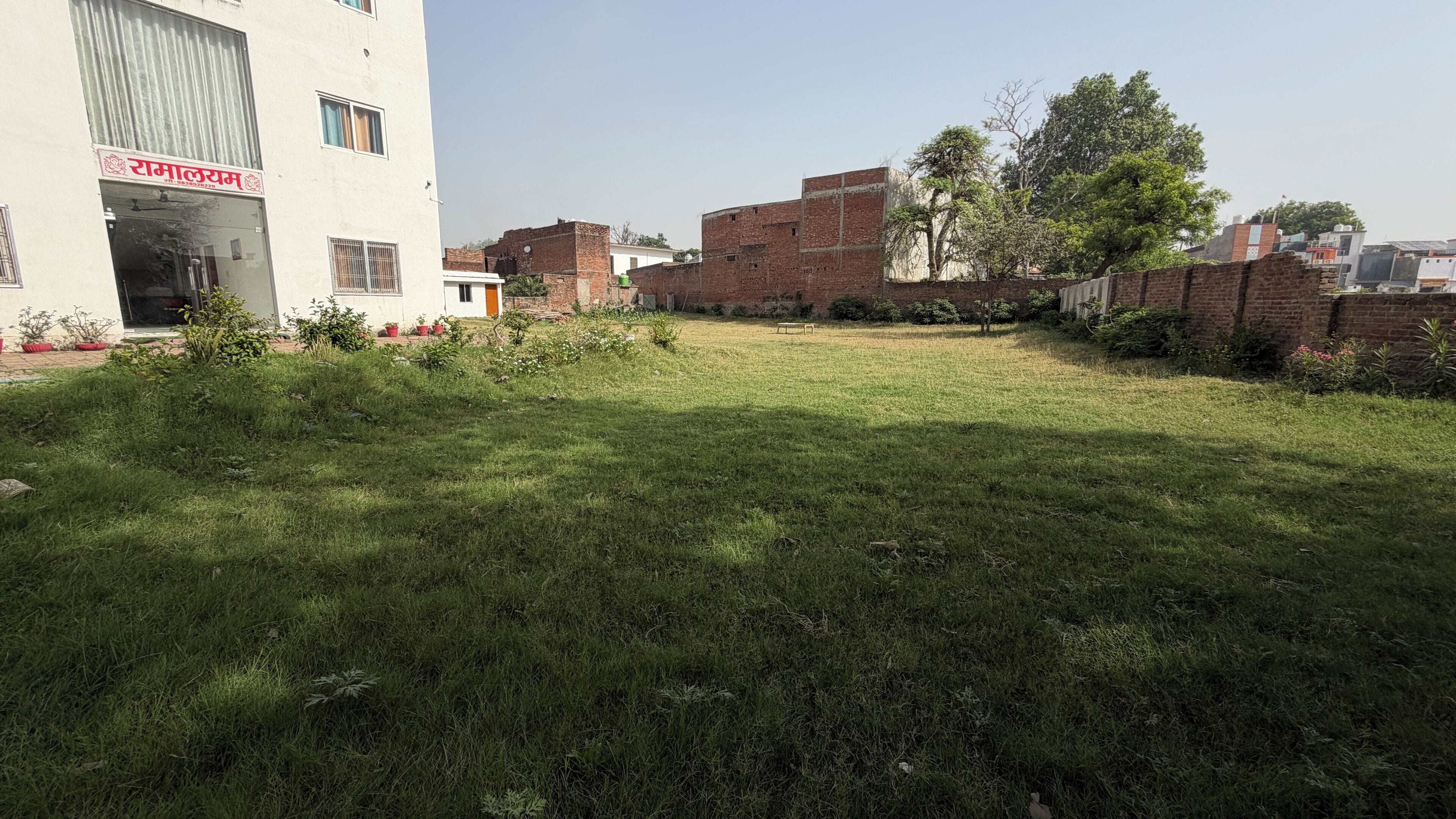 A courtyard with a building labeled 'Ramalram' and a brick wall.