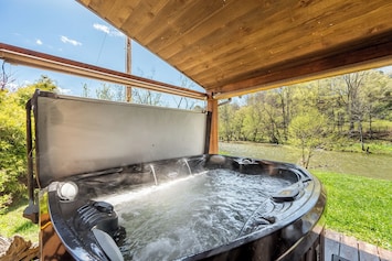 Riverside hot tub with steamy view where you will enjoy listening to the creek while having a relaxing evening