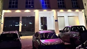 A hotel building with multiple floors, illuminated windows, and a prominent sign reading "AGAYS HOTEL". - 4 Guys Hotels (Muscat)