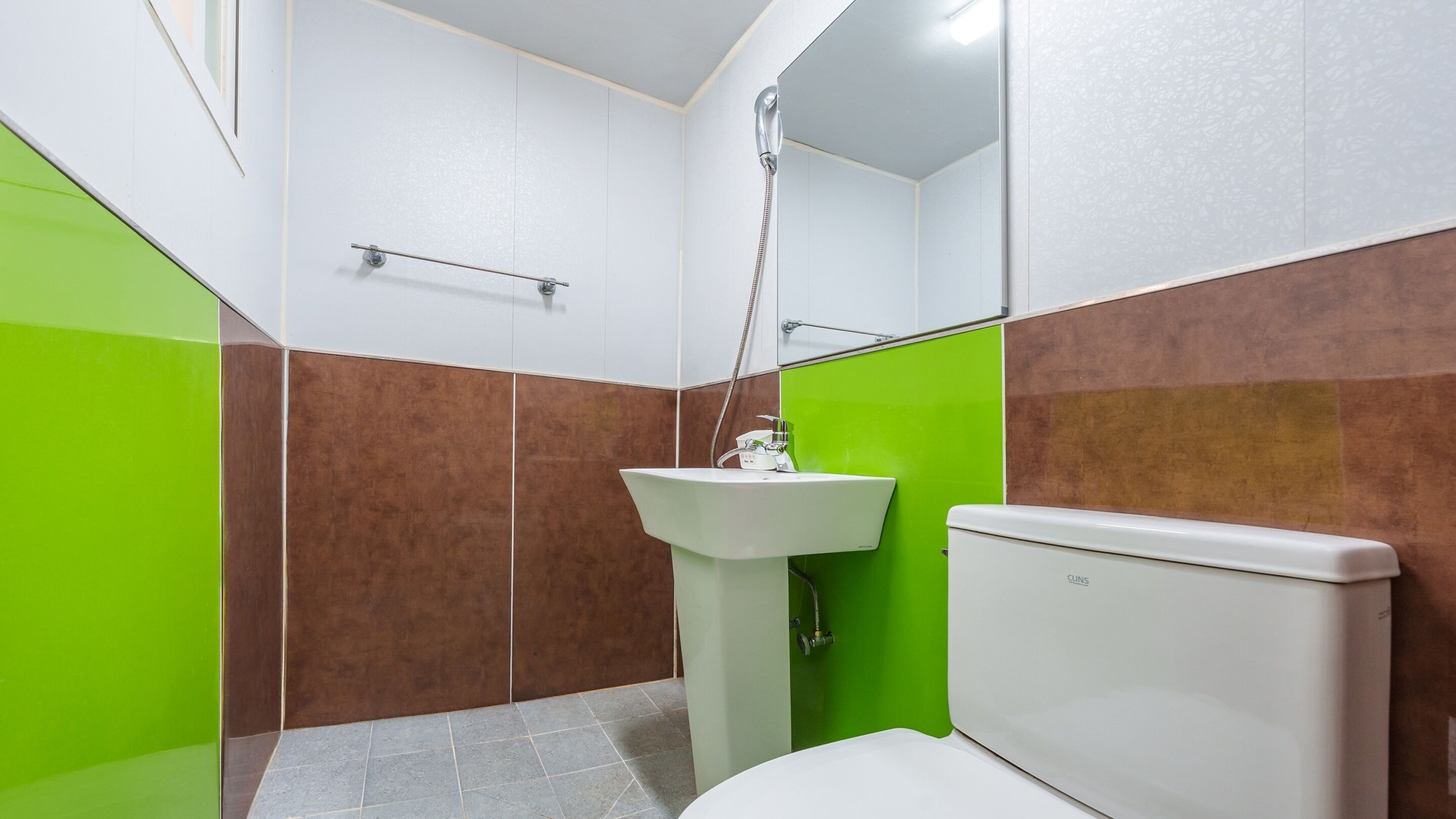 A bathroom with a white toilet, a white sink, and a shower.