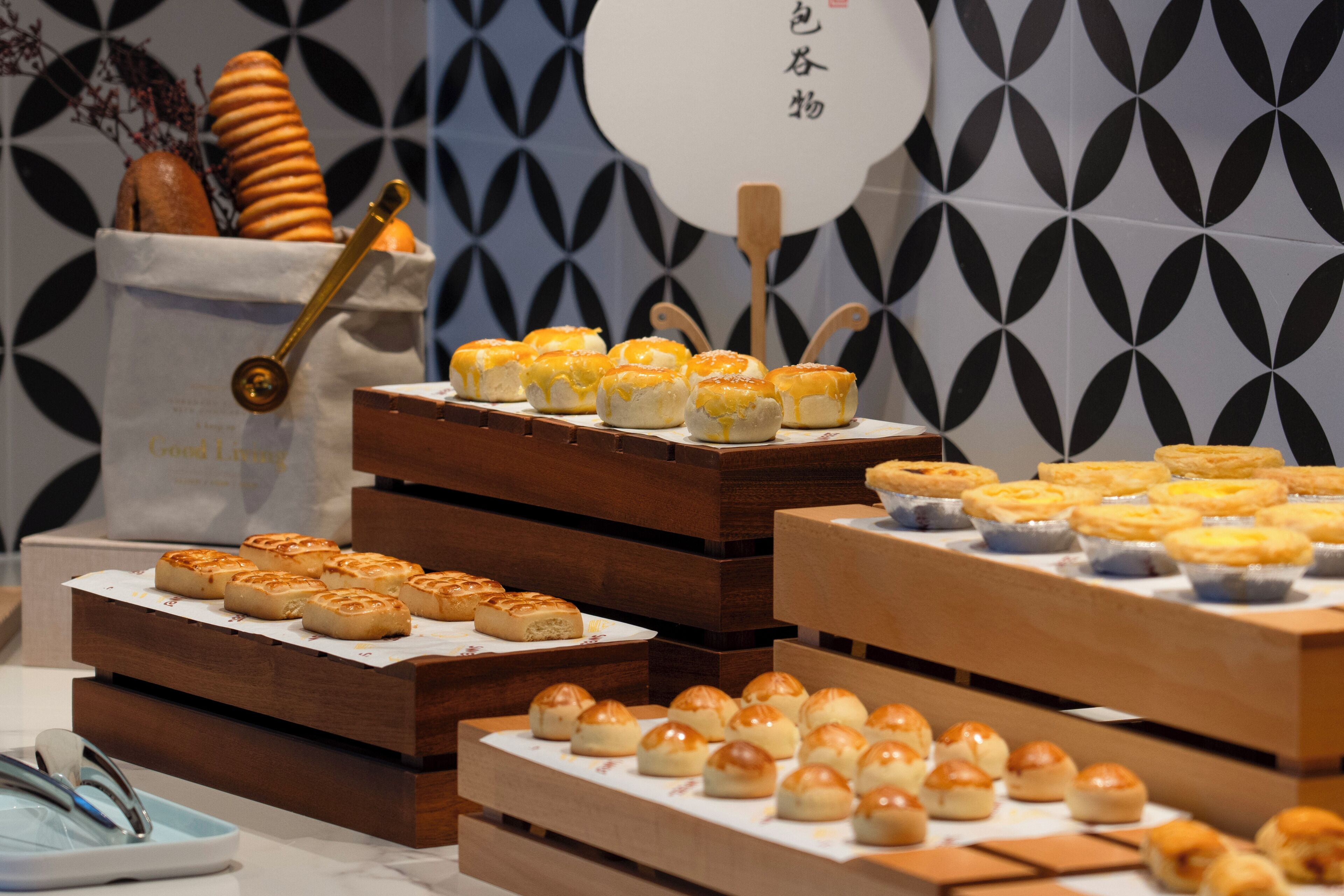 A variety of baked goods displayed on wooden stands.
