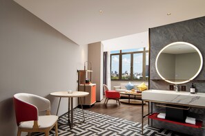 Signature Double Room | Living area | 72-inch LCD TV with cable channels