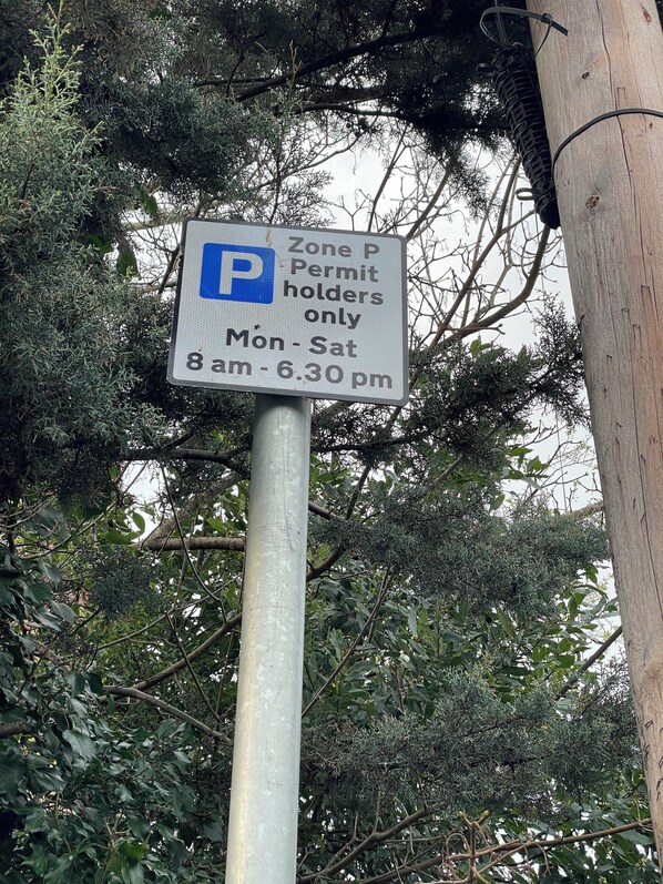 A parking sign indicating a permit holder only zone from 8 am to 6:30 pm, Monday to Saturday. - Golden Triangle Townhouse (Norwich)