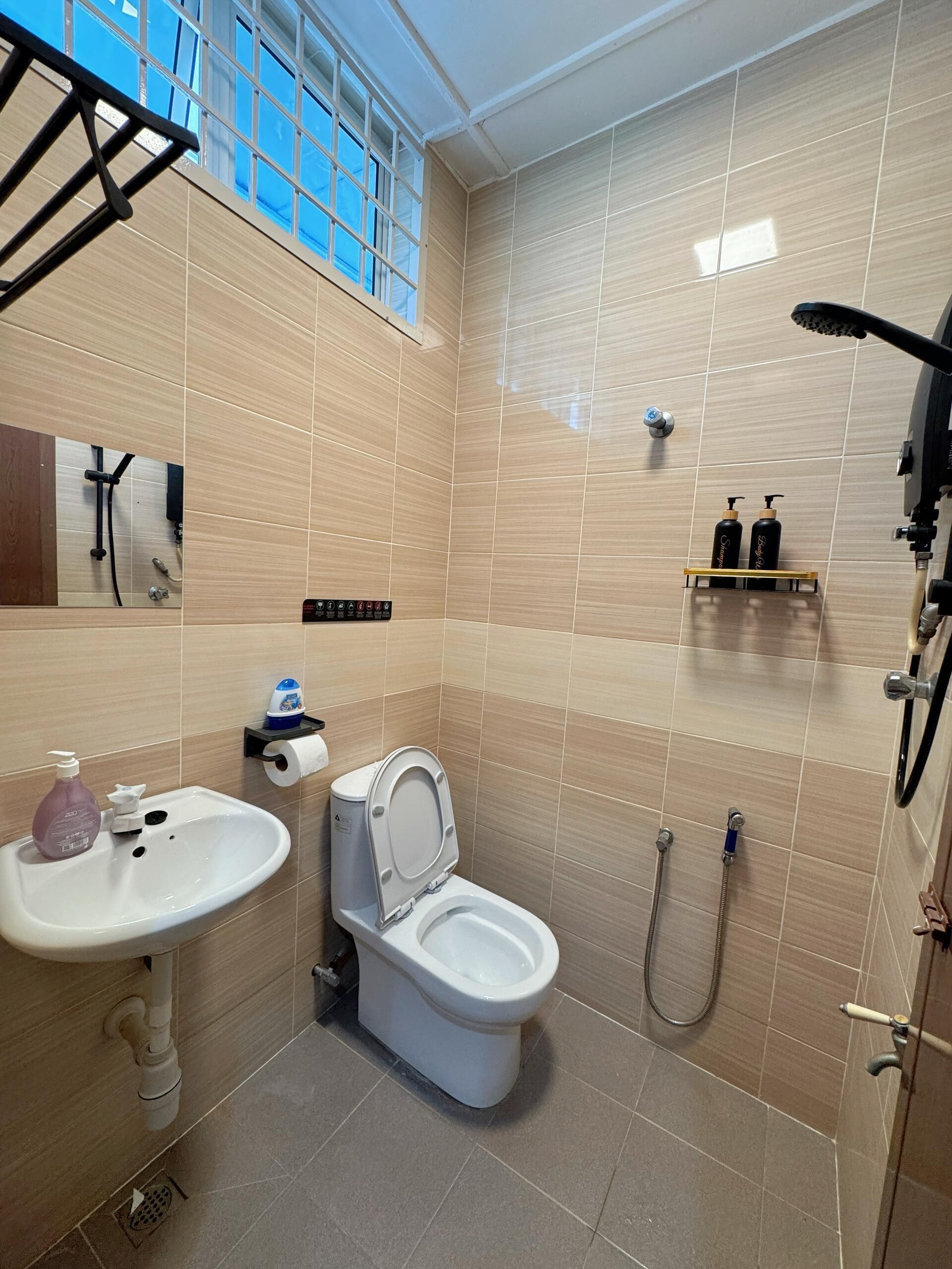 A modern bathroom with a toilet, sink, and shower.