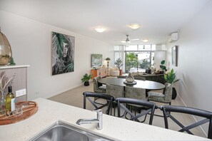 Deluxe Apartment, Balcony, Pool View | Living area | 55-inch Smart TV with cable channels, Netflix, streaming services